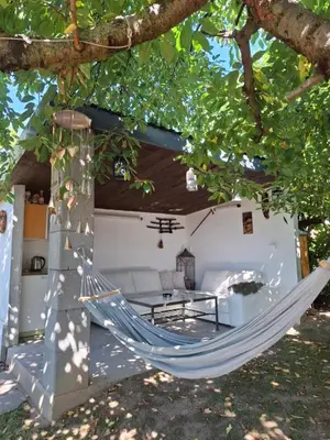 a hammock hanging from a tree in a house at Záhradní chata Kbelská 335 in Prague