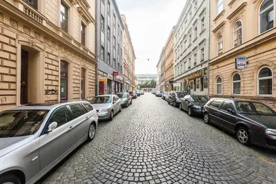 a cobblestone street with cars parked on both sides at Dream city in Prague