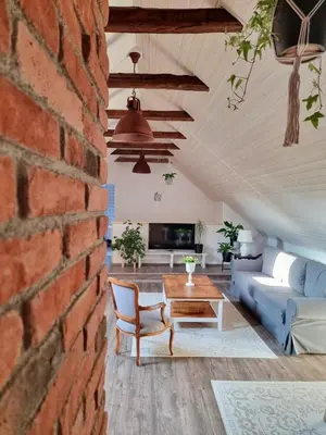 a living room with a brick wall at Apartmán u Stef in Borotice