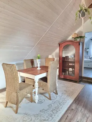 a dining room with a wooden table and chairs at Apartmán u Stef in Borotice