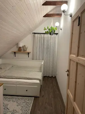a bedroom with a white bed and a ceiling at Apartmán u Stef in Borotice