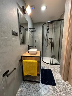 a bathroom with a sink and a shower at Modern Apartment in the Heart of Vršovice in Prague