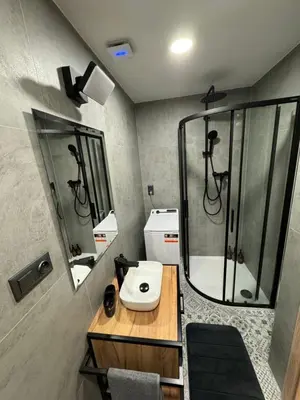 a bathroom with a sink and a shower at Modern Apartment in the Heart of Vršovice in Prague