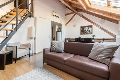 a bedroom with a large bed and a painting on the wall at Riverside Palace Apartments in Prague