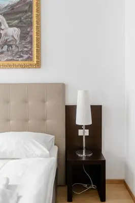 a kitchen with white cabinets and a microwave at Riverside Palace Apartments in Prague