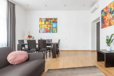 a living room with a couch and a table with chairs at Riverside Palace Apartments in Prague