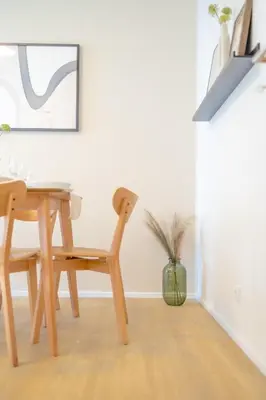 a dining room with a table and a chair at Bright 2BR - 8th floor, Balcony, Free Parking - by Gravity Prague in Prague