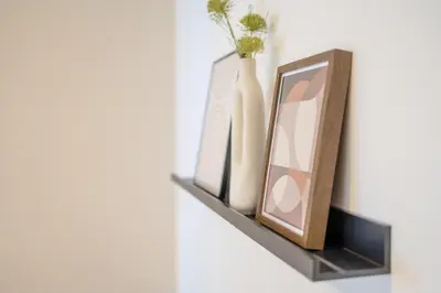 a shelf with two vases and a mirror on it at Bright 2BR - 8th floor, Balcony, Free Parking - by Gravity Prague in Prague