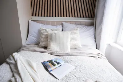 a bedroom with a bed and a desk and a window at Rentero 5 min Dancing House Apartment Prague, Luxury and Modern in Prague