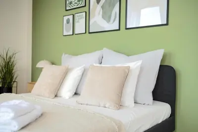 a bedroom with a bed with white pillows at Bright 2BR - 7th floor, Balcony, Free Parking by Gravity Prague in Prague