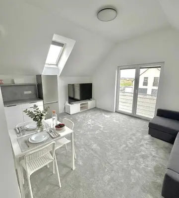a bedroom with a bed and white cabinets at Apartman Amanda - Ohrada in Choťánky