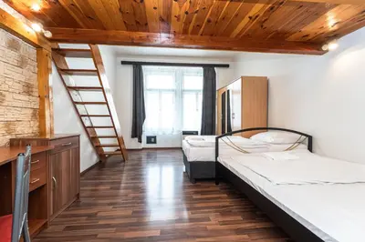 a room with two bunk beds and a staircase at Apartment Charkovska 18 in Prague
