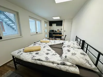 a bedroom with a bed with pillows on it at Útulný apartmán v klidné části Benešova in Benešov