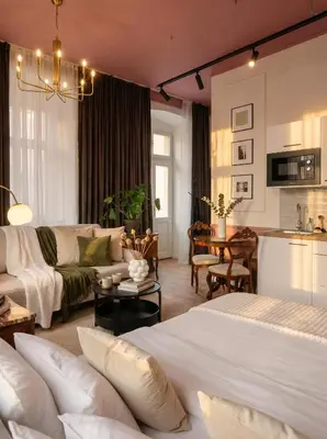 a bedroom with a bed and a living room at TurnKey I Antonin Dvorak Apartments in Prague