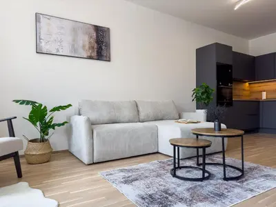 a living room with a couch and a table at Central Riverside Apartment - Free Parking in Prague