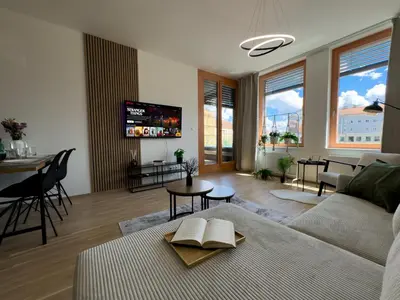 a living room with a couch and a table at Central Riverside Apartment - Free Parking in Prague