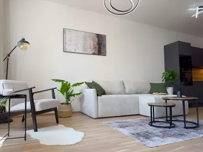 a living room with a couch and a table at Central Riverside Apartment - Free Parking in Prague