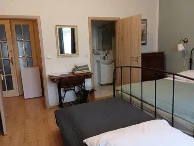 a bedroom with a bed and a desk in a room at Apartments Bouquet in Prague