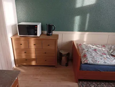 a bedroom with a bed and a microwave on a dresser at Apartments Bouquet in Prague