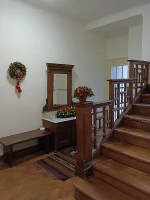 a room with stairs and a mirror and flowers at Apartments Bouquet in Prague