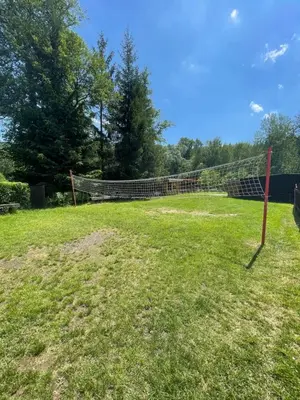 a net in the middle of a grass field at Penzion Černý Mlýn in Dubá