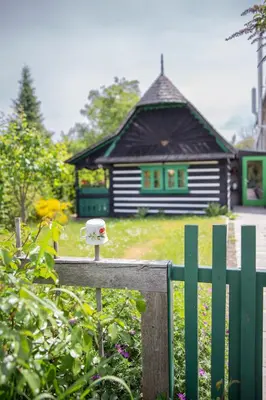 a small house with a bird feeder on a fence at Chaloupka Křivoklát in Křivoklát