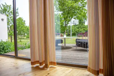 a room with a sliding glass door to a deck at Chaloupka Křivoklát in Křivoklát