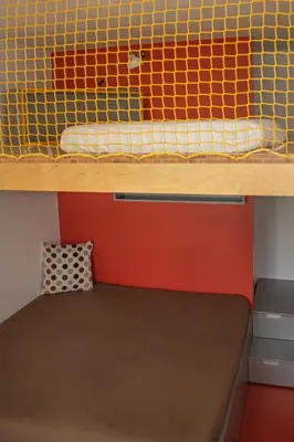 a bunk bed in a small room with a brown mattress at Chaloupka Křivoklát in Křivoklát