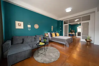 a living room with a couch and a blue wall at 3B Bright Beautiful Newly Renovated 3BR in Prague