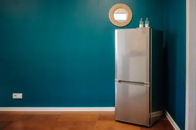 a refrigerator in a room with a blue wall at 3B Bright Beautiful Newly Renovated 3BR in Prague