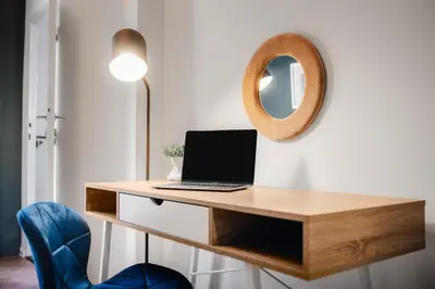a desk with a laptop and a mirror on a wall at 3B Bright Beautiful Newly Renovated 3BR in Prague