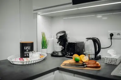 a kitchen counter with a microwave and some food on it at 3B Bright Beautiful Newly Renovated 3BR in Prague