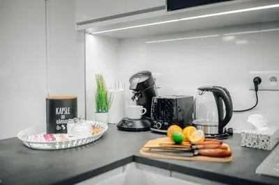 a kitchen counter with a toaster and a cutting board with food at 3B Bright Beautiful Newly Renovated 3BR in Prague