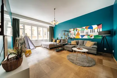 a living room with a couch and a table at Cityscape Charm Spacious 3 Bedroom Haven for 7 in Prague