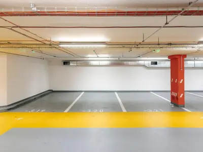 an empty parking garage with a red pole in it at Cityscape Charm Spacious 3 Bedroom Haven for 7 in Prague