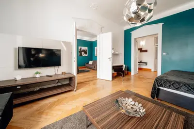 a living room with a large flat screen tv at Heritage Haven Charming 3BR City Center in Prague