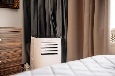 a computer in a bedroom next to a curtain at Heritage Haven Charming 3BR City Center in Prague