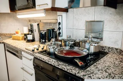a kitchen counter with pots and pans on a stove at Heritage Haven Charming 3BR City Center in Prague