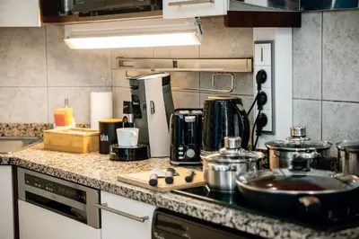 a kitchen with a counter top with pots and pans at Heritage Haven Charming 3BR City Center in Prague