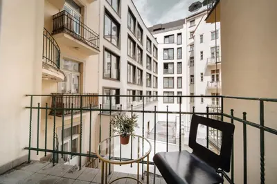 a balcony with a bench and a potted plant at Heritage Haven Charming 3BR City Center in Prague