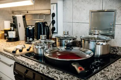 a kitchen counter with pots and pans on a stove at Heritage Haven Charming 3BR City Center in Prague