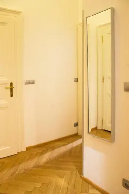 an empty room with a mirror on the wall at Modern Apartment Všehrdova in Prague