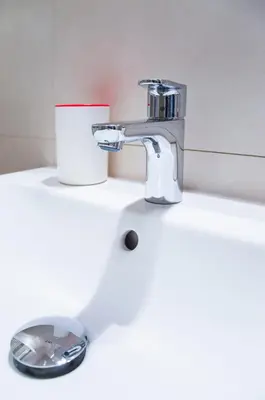 a bathroom sink with a faucet and a bowl at Modern Apartment Všehrdova in Prague