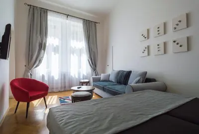 a living room with a bed and a couch at Design Apartment Havelska in Prague