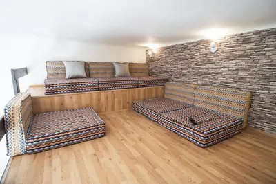 a room with two couches and a brick wall at Design Apartment Havelska in Prague