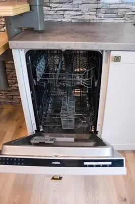an oven with its door open with its dishes inside at Design Apartment Havelska in Prague