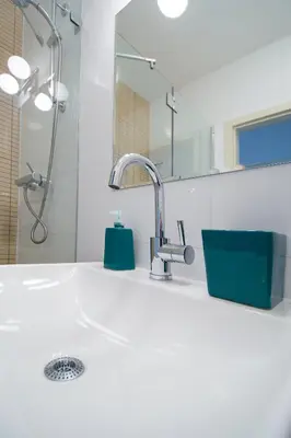 a bathroom counter with a sink and a shower at Modern Apartment Charvátova in Prague