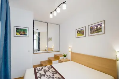 a bedroom with two beds and a mirror at Modern Apartment Charvátova in Prague