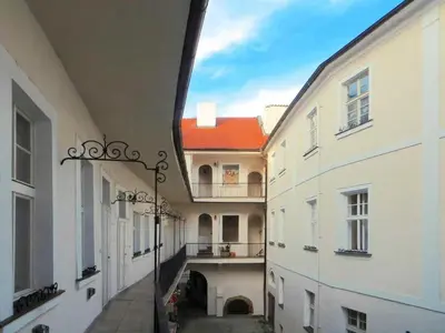 an alleyway between two white buildings with a red roof at Apartment Old Town home-2 by Interhome in Prague