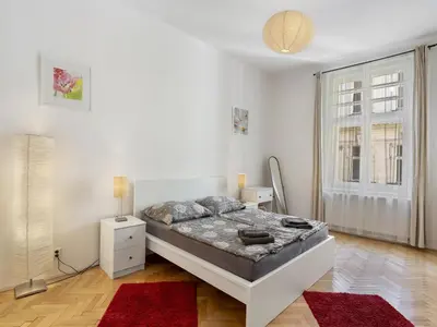 a white bedroom with a bed and a window at Apartment Old Town home-2 by Interhome in Prague